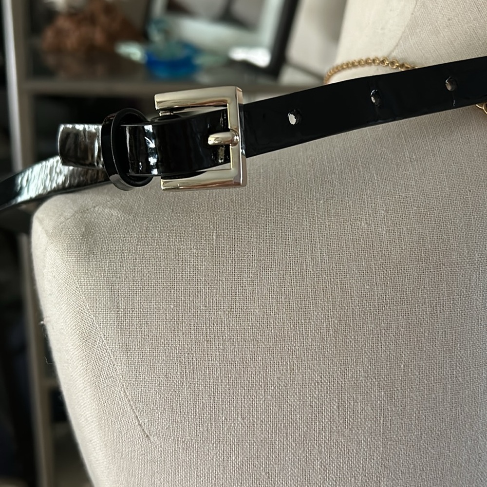 Black patent leather belt.